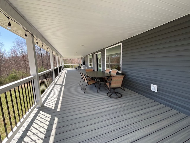 deck featuring outdoor dining area
