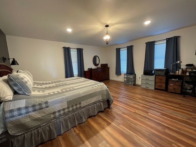bedroom with baseboards and wood finished floors