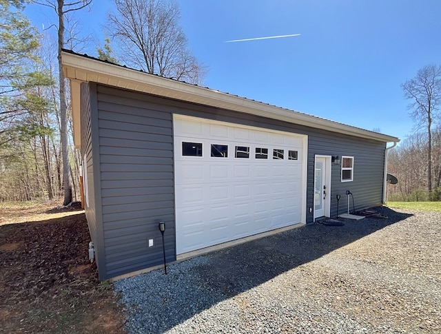 garage featuring dirt driveway