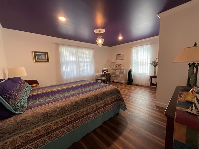 bedroom with recessed lighting and wood finished floors