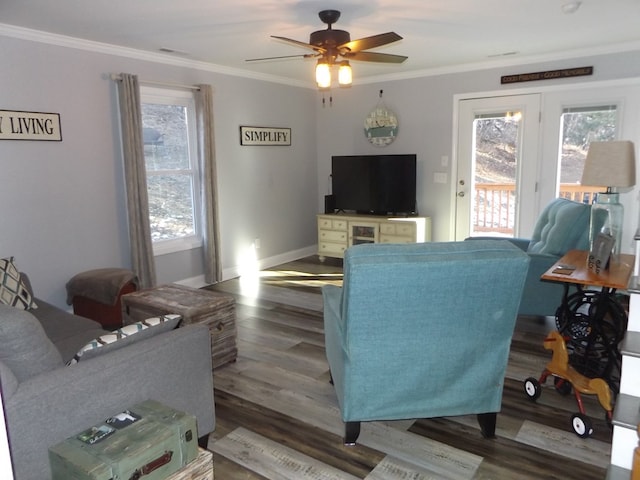 living room with crown molding, ceiling fan, and dark hardwood / wood-style floors