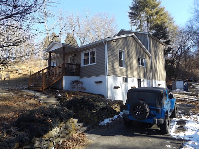 view of snow covered exterior featuring a storage unit