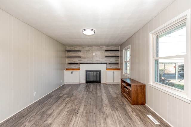 824 Skyview Dr, Chilhowie, VA 24319 - unfurnished living room with visible vents, wood finished floors, and a glass covered fireplace