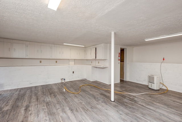 824 Skyview Dr, Chilhowie, VA 24319 - finished basement with dark wood-style floors and a textured ceiling