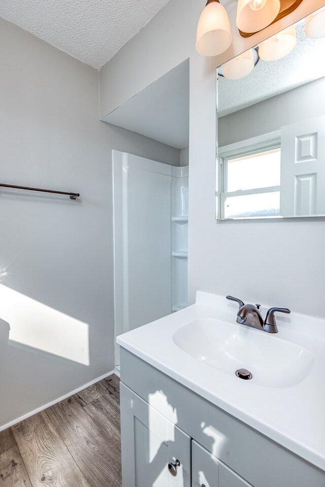 824 Skyview Dr, Chilhowie, VA 24319 - full bath featuring vanity, baseboards, walk in shower, a textured ceiling, and wood finished floors