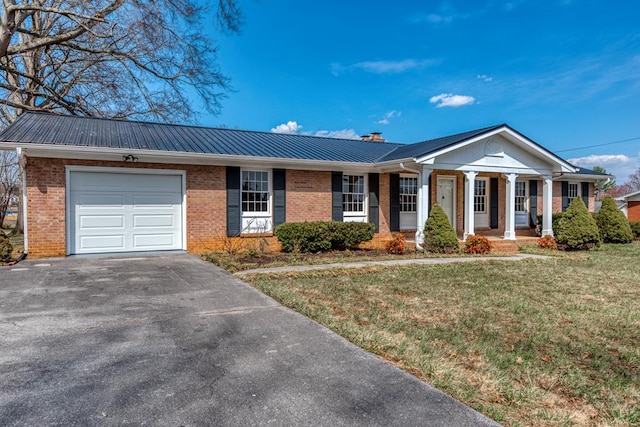 867 NE Wayne Ave, Abingdon, VA 24210 - view of front facade featuring brick siding, an attached garage, a porch, a front lawn, and a chimney