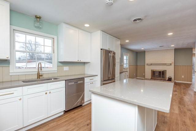 867 NE Wayne Ave, Abingdon, VA 24210 - kitchen featuring stainless steel appliances, white cabinetry, a kitchen island, light wood-style flooring, and recessed lighting