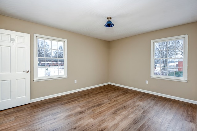 867 NE Wayne Ave, Abingdon, VA 24210 - unfurnished bedroom with wood finished floors and multiple windows