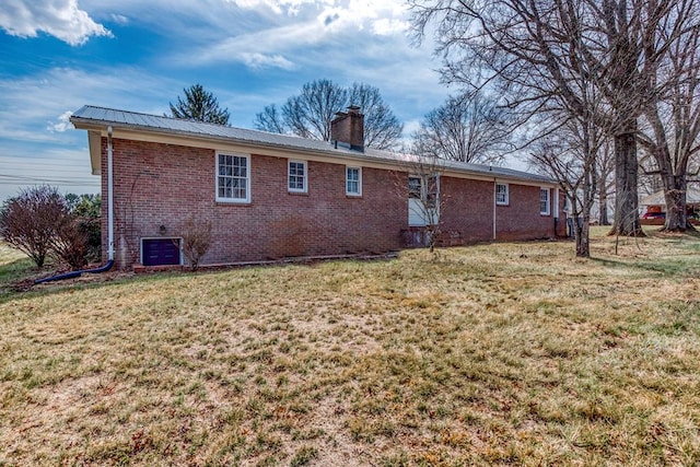 867 NE Wayne Ave, Abingdon, VA 24210 - rear view of property with brick siding, a chimney, a lawn, and a metal roof