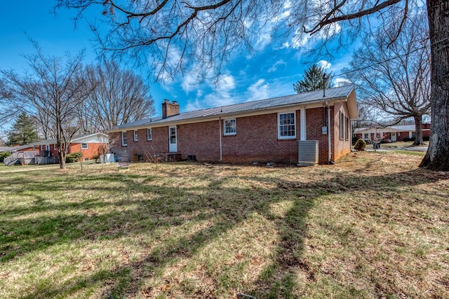 867 NE Wayne Ave, Abingdon, VA 24210 - rear view of house featuring a chimney, brick siding, a metal roof, and a lawn