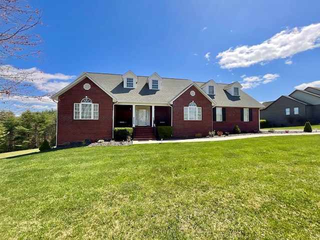 cape cod-style house featuring brick siding, crawl space, and a front yard