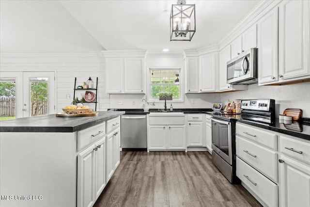 10601 W River Vue, Biloxi, MS 39532 - kitchen featuring appliances with stainless steel finishes, dark countertops, dark wood-style floors, white cabinets, and recessed lighting