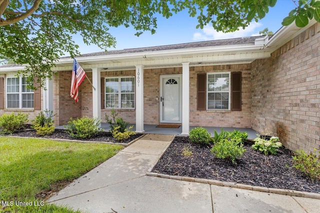 10601 W River Vue, Biloxi, MS 39532 - entrance to property featuring brick siding, a porch, and a lawn