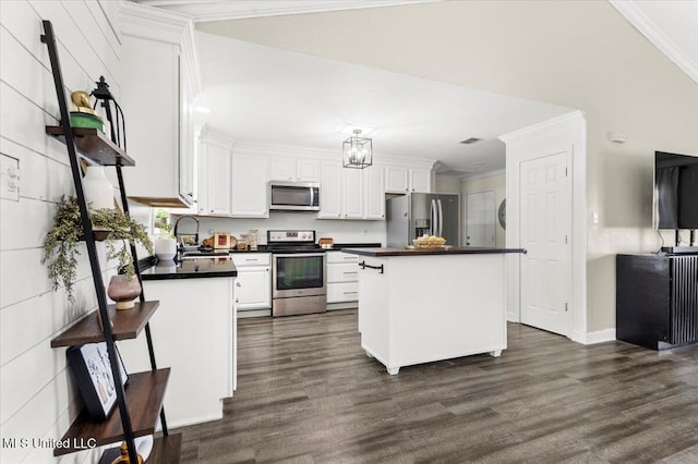 10601 W River Vue, Biloxi, MS 39532 - kitchen with appliances with stainless steel finishes, dark countertops, white cabinetry, dark wood-style floors, and crown molding