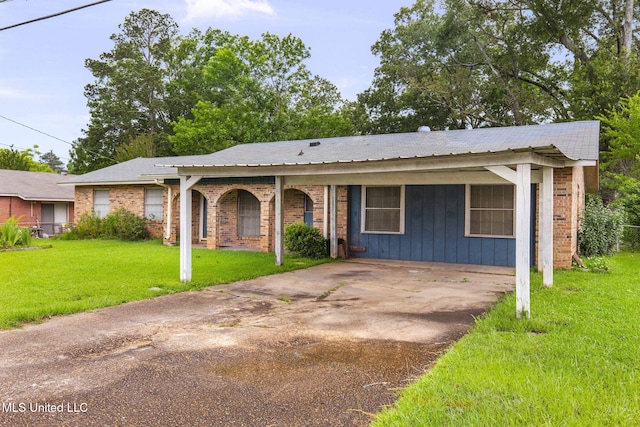 3608 Old Brandon Rd, Pearl, MS 39208 - view of front of house featuring a front lawn, brick siding, and driveway