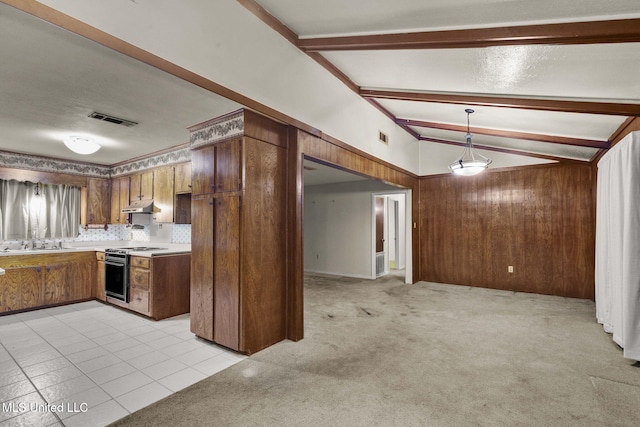 3608 Old Brandon Rd, Pearl, MS 39208 - kitchen with under cabinet range hood, electric range, brown cabinetry, a sink, and light countertops