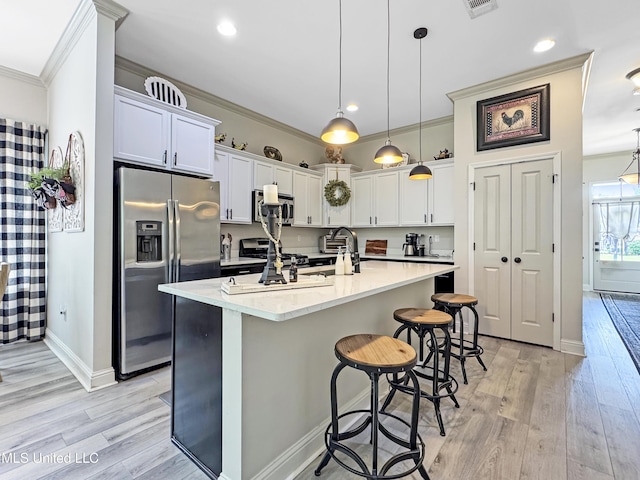 14 Le Petit Cv, Long Beach, MS 39560 - kitchen featuring appliances with stainless steel finishes, ornamental molding, light wood-style floors, a breakfast bar, and hanging light fixtures