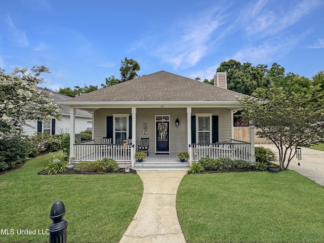 14 Le Petit Cv, Long Beach, MS 39560 - bungalow-style house with covered porch, a chimney, a front yard, and a shingled roof