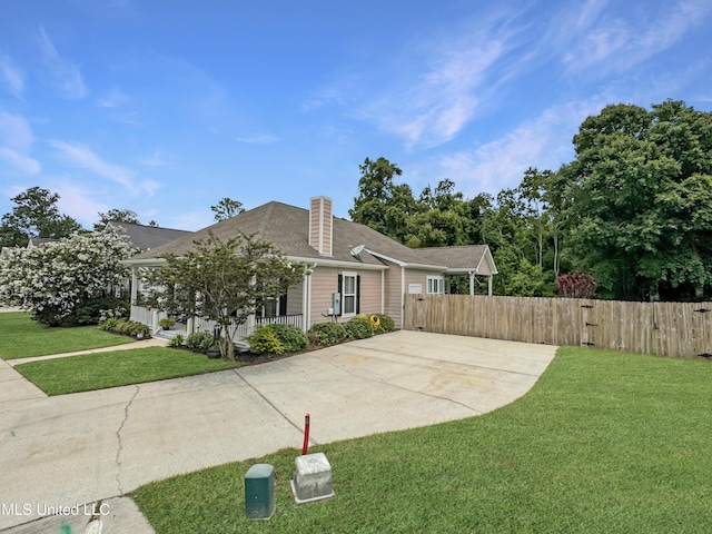 14 Le Petit Cv, Long Beach, MS 39560 - view of front facade with concrete driveway, a shingled roof, and a chimney