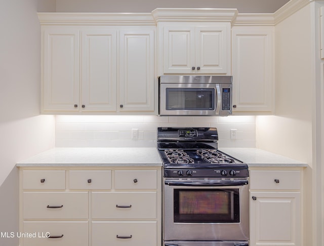 130 Covey Run, Madison, MS 39110 - kitchen with stainless steel appliances, tasteful backsplash, and white cabinetry