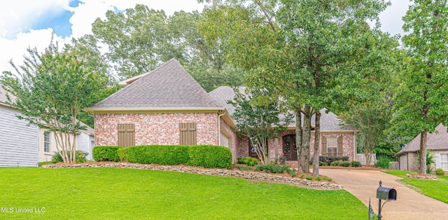 130 Covey Run, Madison, MS 39110 - view of front facade featuring a front lawn, brick siding, a shingled roof, and an attached garage