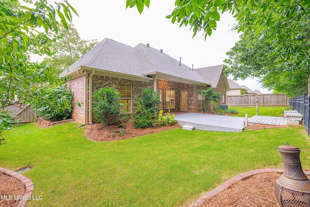 130 Covey Run, Madison, MS 39110 - rear view of house featuring roof with shingles, a patio, brick siding, and a fenced backyard