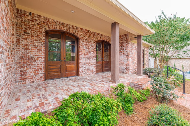 130 Covey Run, Madison, MS 39110 - doorway to property with french doors, brick siding, and covered porch