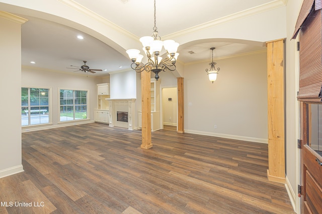 130 Covey Run, Madison, MS 39110 - unfurnished living room featuring ceiling fan, arched walkways, dark wood finished floors, a glass covered fireplace, and ornamental molding