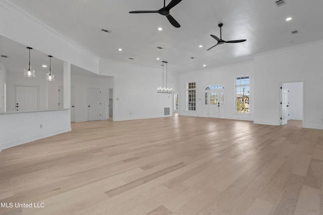 unfurnished living room featuring crown molding, light hardwood / wood-style flooring, and ceiling fan with notable chandelier