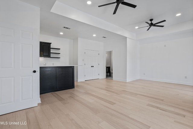 unfurnished living room with light hardwood / wood-style floors and ceiling fan