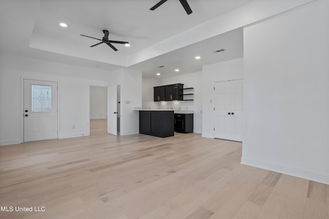 unfurnished living room featuring light hardwood / wood-style floors and ceiling fan