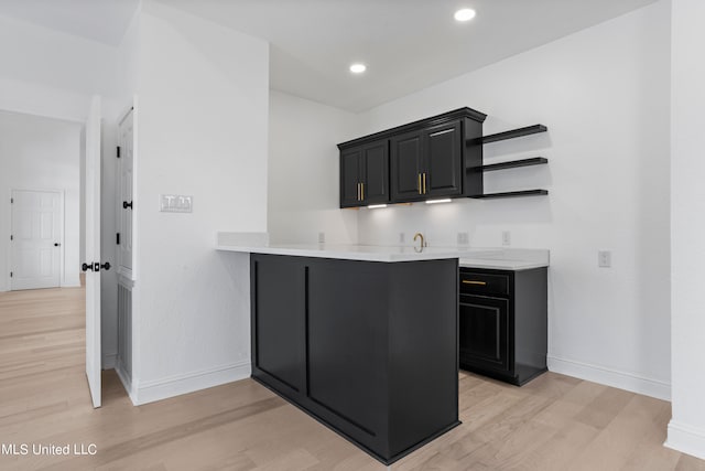 kitchen with light hardwood / wood-style floors and kitchen peninsula