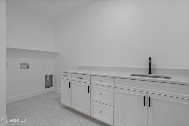 washroom featuring sink and cabinets