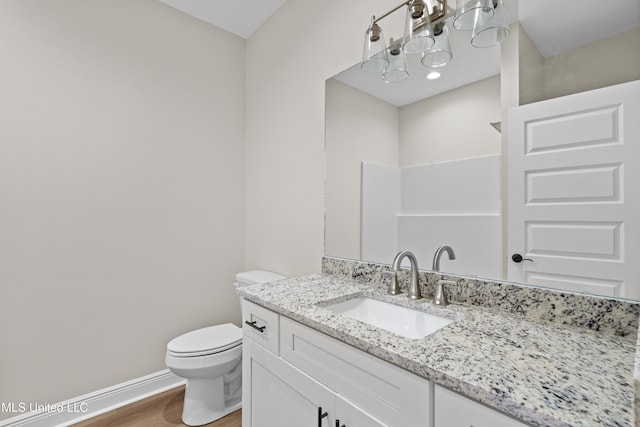 bathroom featuring walk in shower, hardwood / wood-style floors, vanity, and toilet