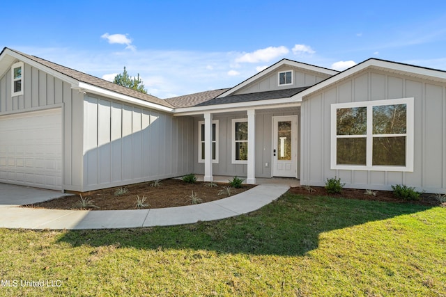 view of front of house with a garage and a front lawn