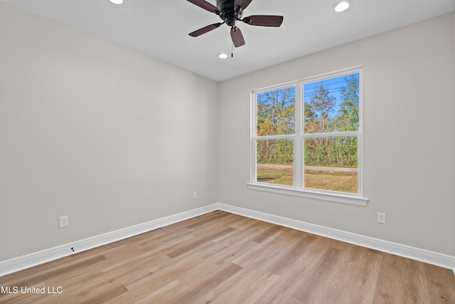 spare room featuring ceiling fan and light wood-type flooring