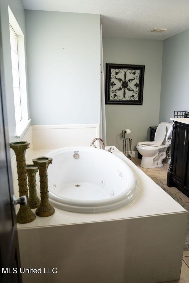 6816 Natchez St, Biloxi, MS 39532 - bathroom with a jetted tub and tile patterned flooring