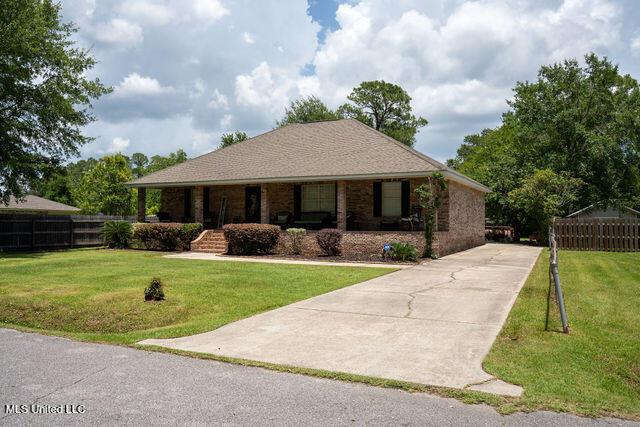 6816 Natchez St, Biloxi, MS 39532 - view of front of property with covered porch, driveway, and brick siding
