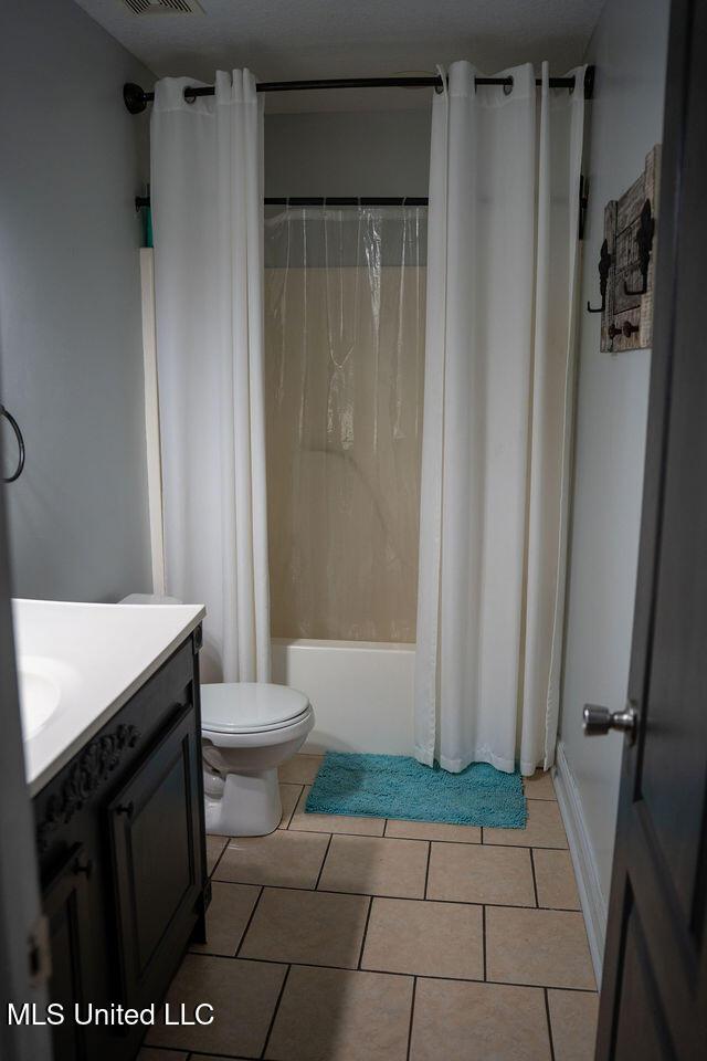 6816 Natchez St, Biloxi, MS 39532 - bathroom with vanity, shower / bathtub combination with curtain, and tile patterned floors