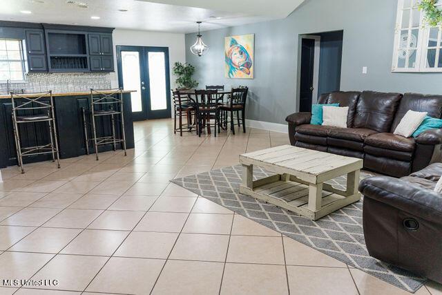 6816 Natchez St, Biloxi, MS 39532 - living area featuring light tile patterned floors and french doors
