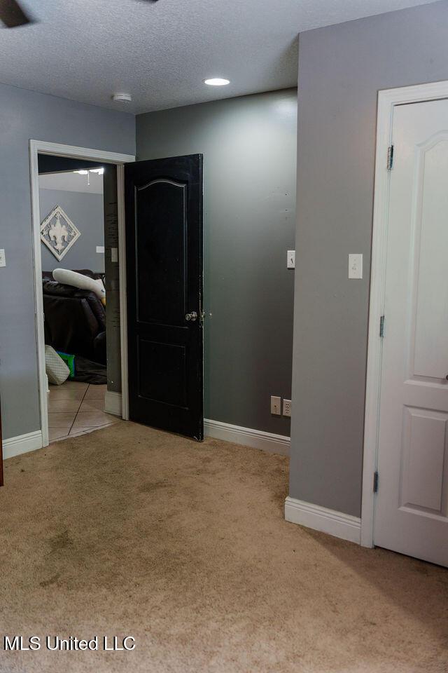6816 Natchez St, Biloxi, MS 39532 - corridor with carpet flooring and a textured ceiling