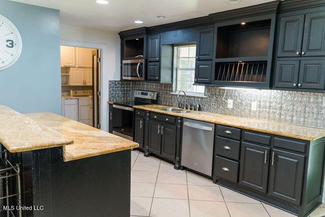6816 Natchez St, Biloxi, MS 39532 - kitchen with appliances with stainless steel finishes, open shelves, backsplash, light tile patterned flooring, and recessed lighting