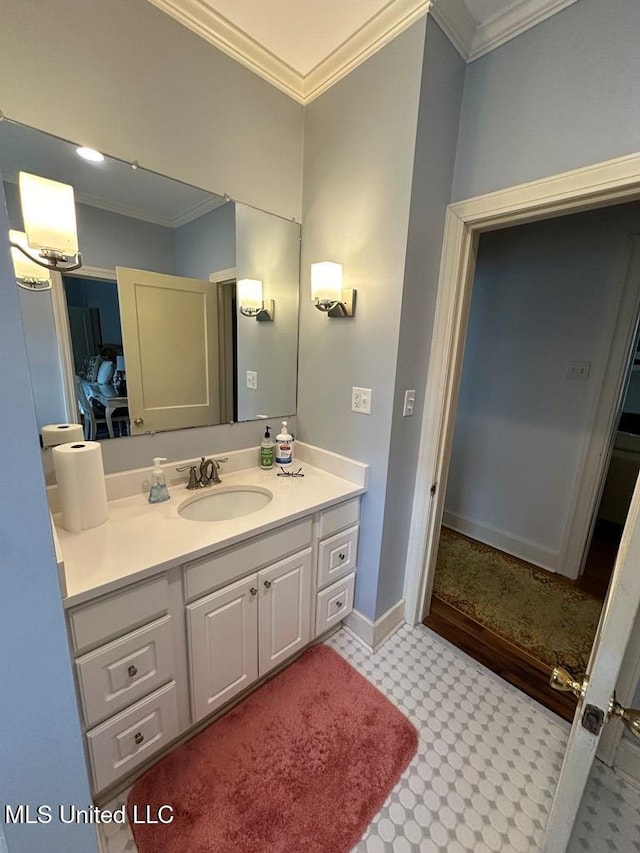 bathroom with crown molding, vanity, and baseboards