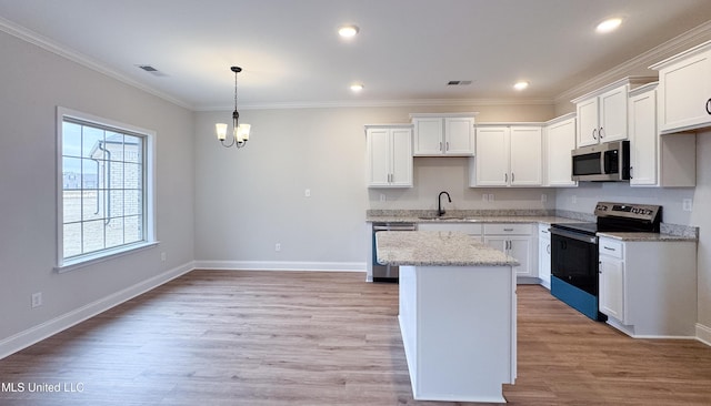 kitchen featuring light wood-type flooring, stainless steel appliances, visible vents, and white cabinets