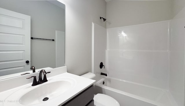 bathroom featuring toilet, vanity, and bathing tub / shower combination