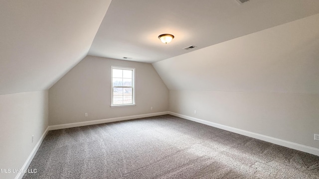 additional living space with lofted ceiling, carpet flooring, baseboards, and visible vents