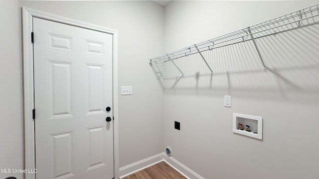 laundry room with wood finished floors, baseboards, hookup for an electric dryer, hookup for a washing machine, and laundry area