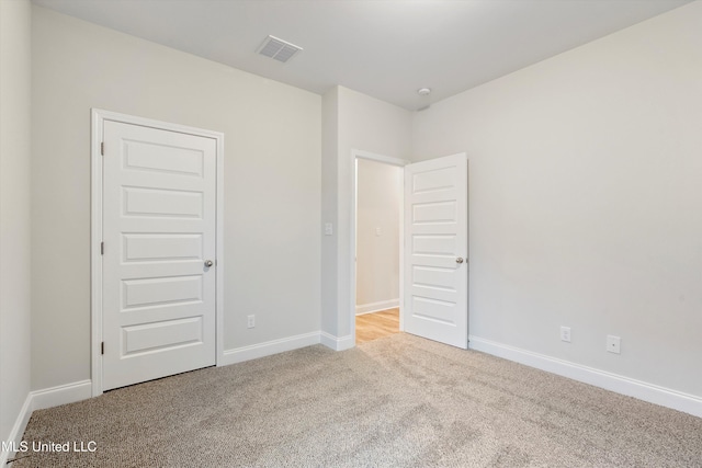 unfurnished bedroom with visible vents, baseboards, and carpet flooring