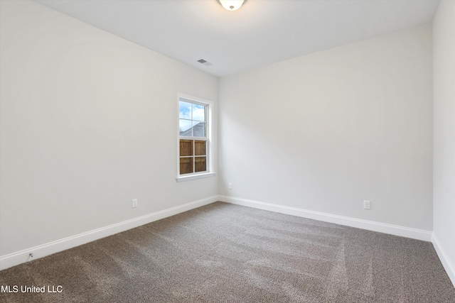 unfurnished room featuring visible vents, baseboards, and carpet