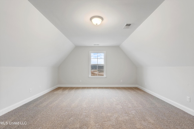 bonus room featuring visible vents, baseboards, lofted ceiling, and carpet flooring